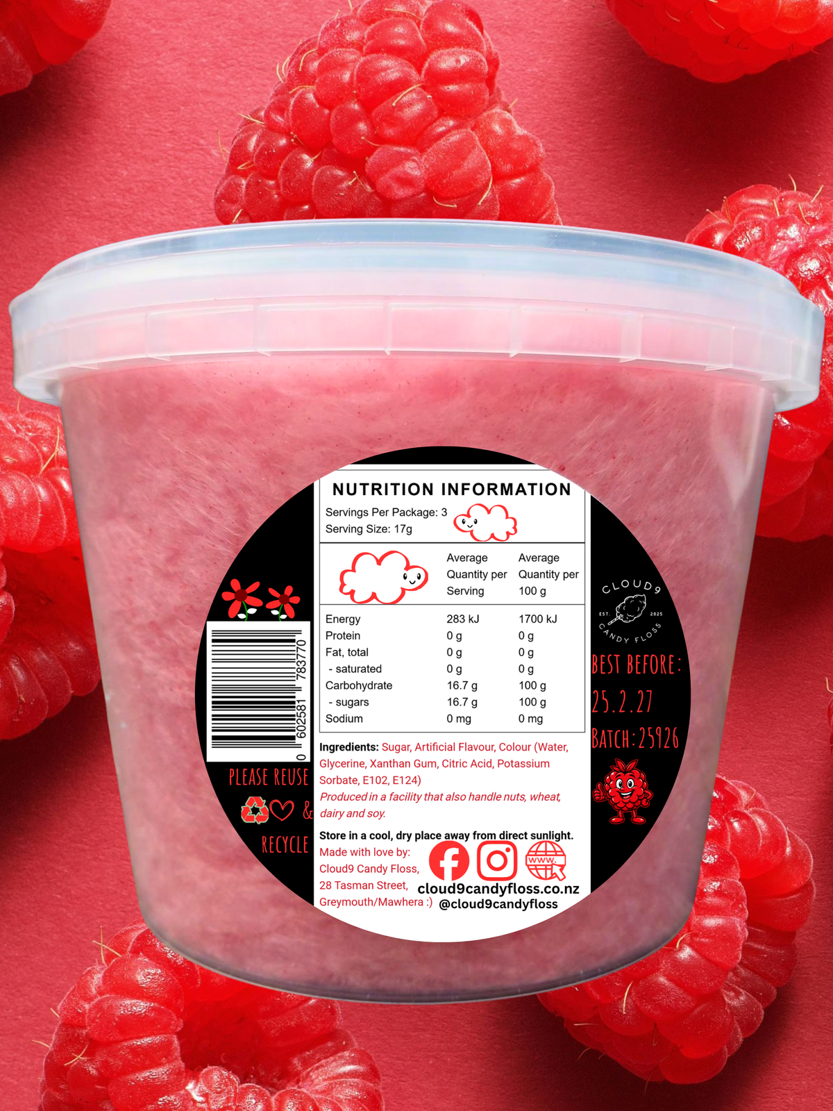 Pink candy floss in a clear tub upon pink background with juicy raspberries.  